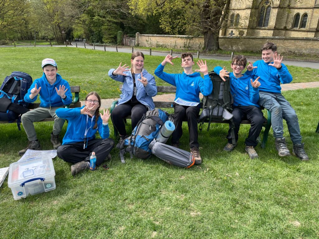 DofE Students in a field with camping gear on