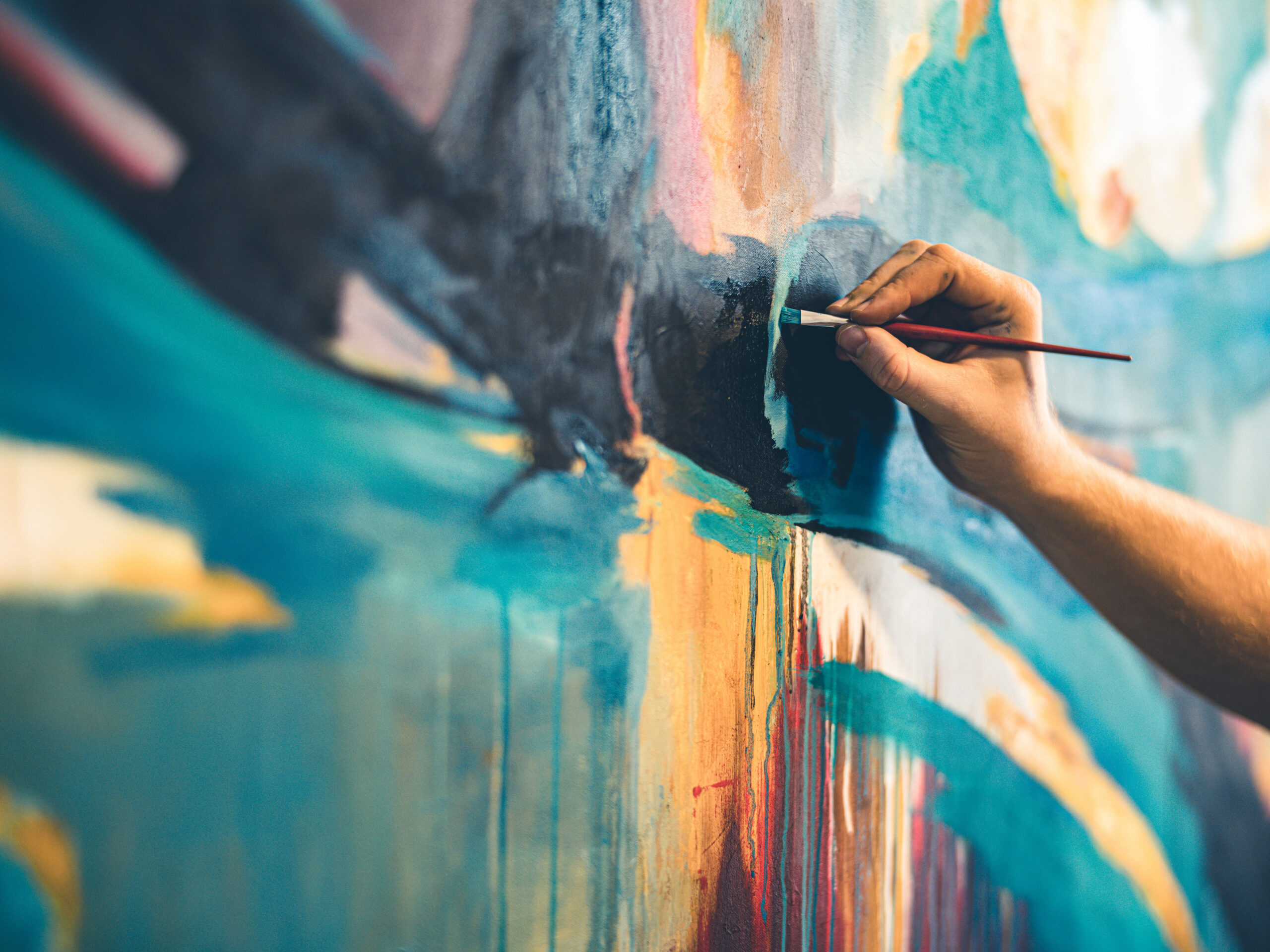Hands of Young painter working on his art inside his studio.