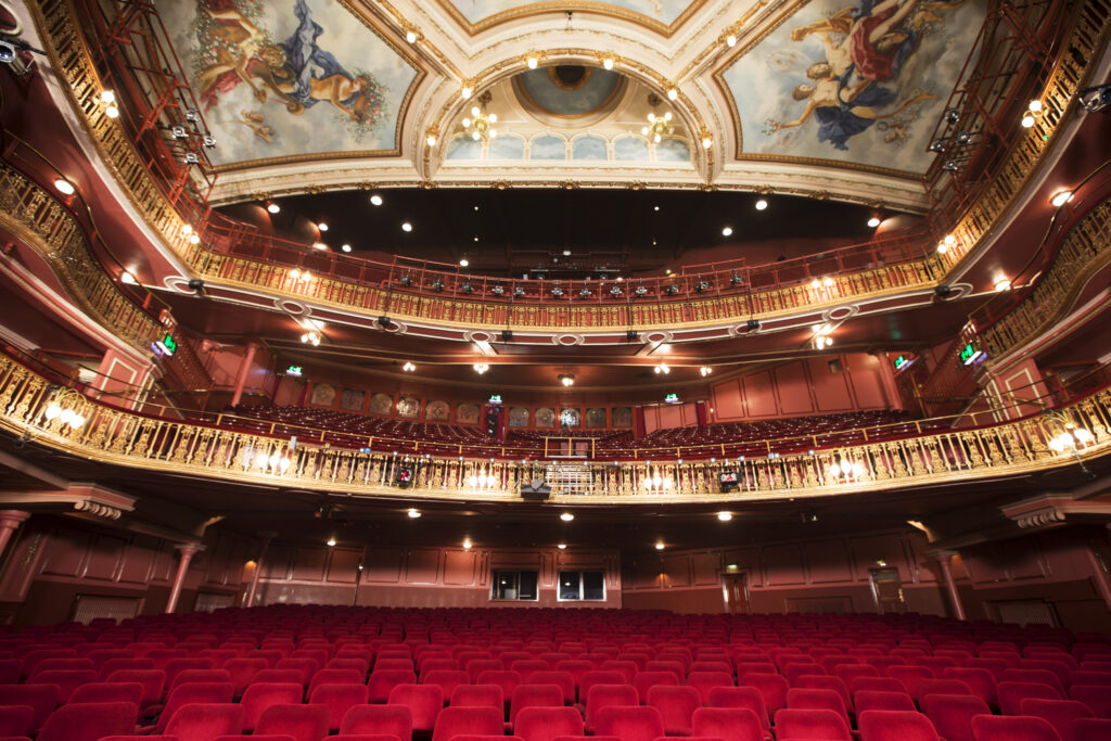 Balcony, seats and ornate ceiling in theater auditorium