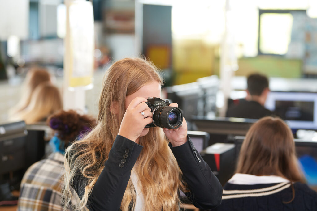Student holding camera