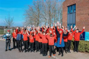 Students wearing red stood outside the Mascalls Building