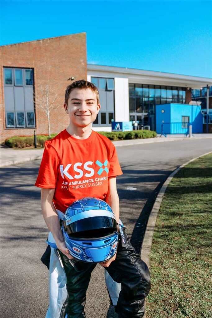 Thomas stood with his racing gear on and a KSS t-shirt